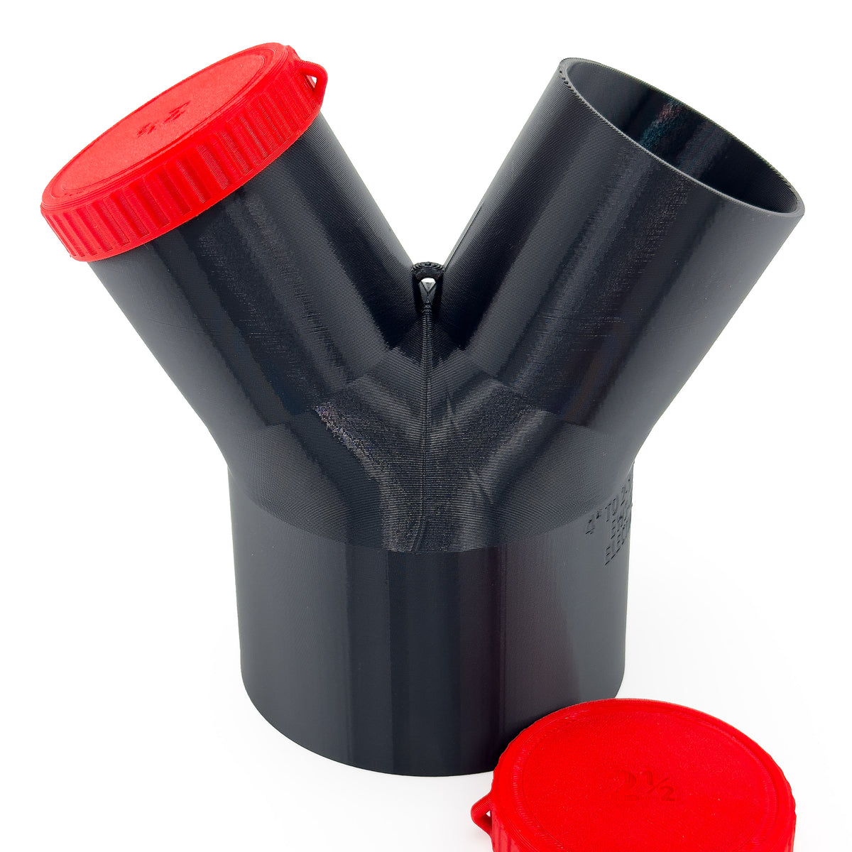 Black Dust Medusa 2-way dust collection splitter standing upright with one red cap fitted and one loose.
