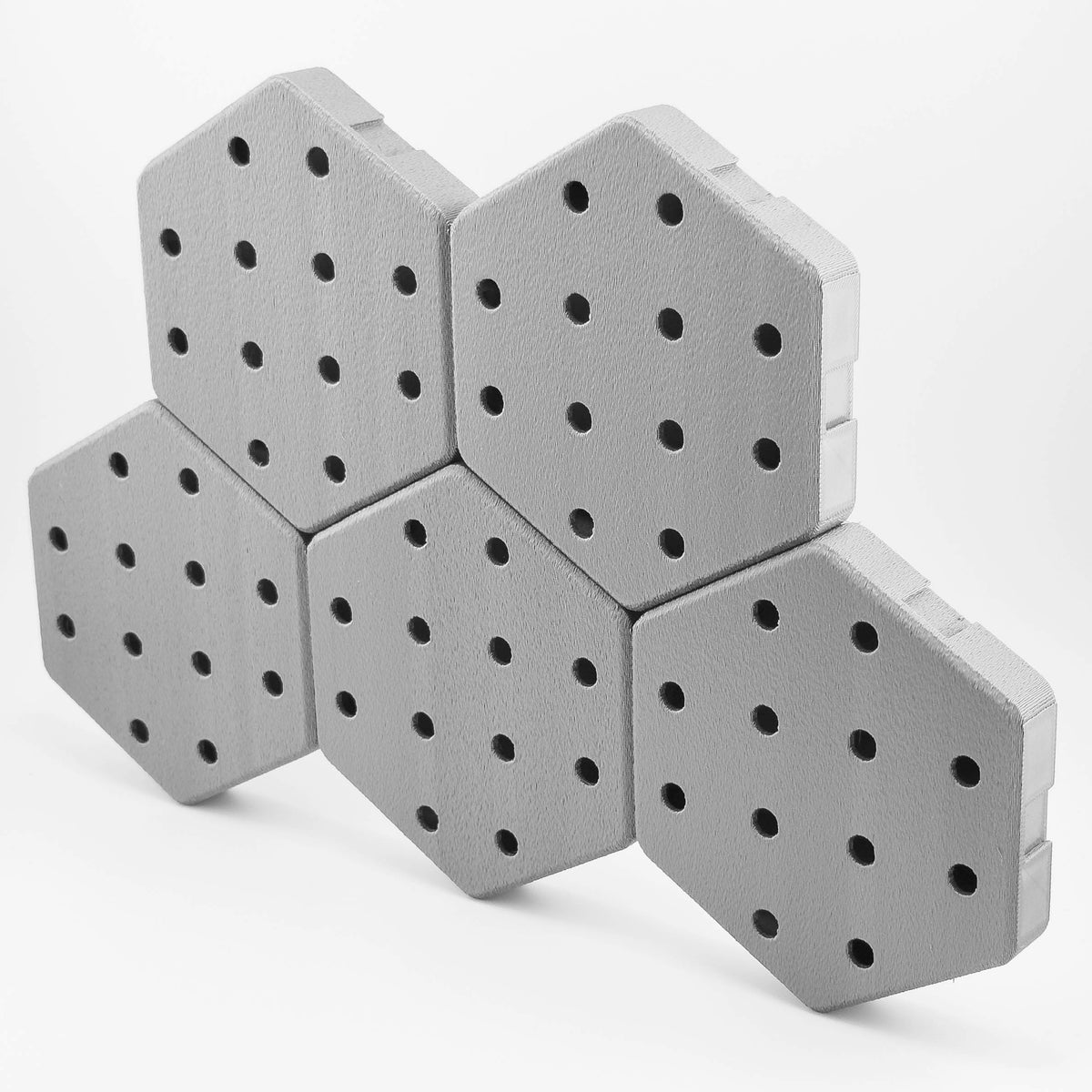 Five connected Hexboard hexagon pegboard tiles in Steel Gray.