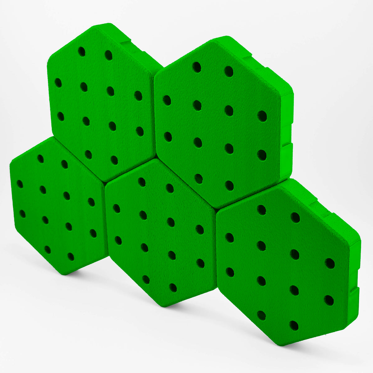 Five connected Hexboard hexagon pegboard tiles in Jungle Green.